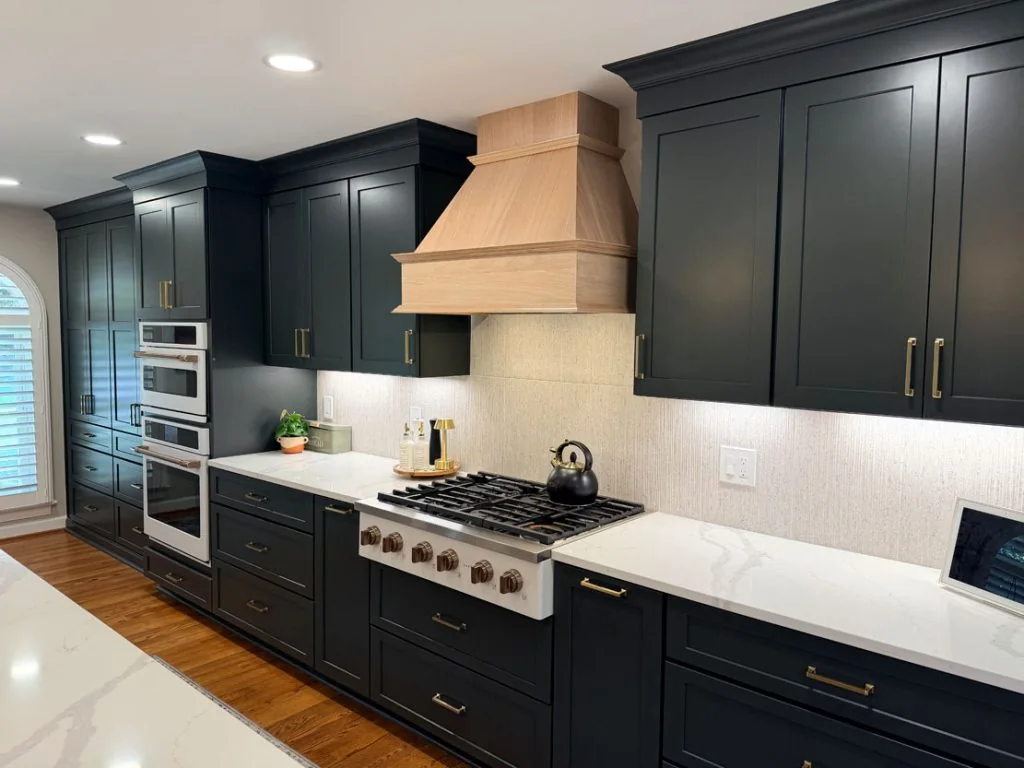 Dark kitchen with wood range hood